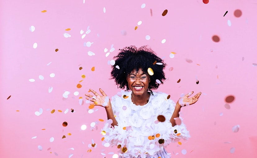 Woman celebrating Ibotta's $500 Million Moment with Confetti