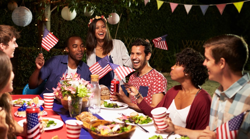 People celebrating the 4th of July outdoors around a table