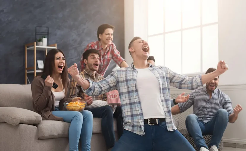 Game day cheering on a couch