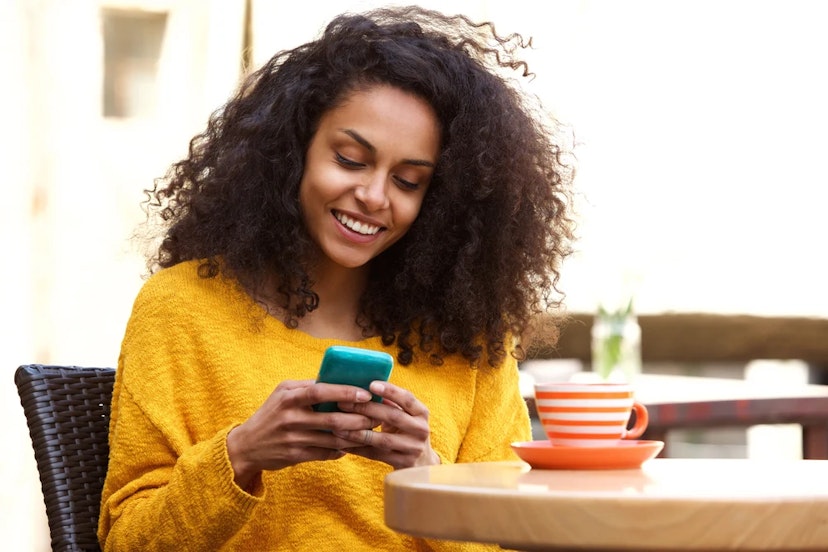 Woman on a phone using Pay with Ibotta