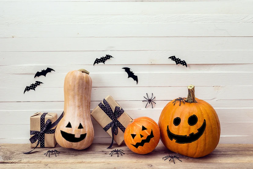 pumpkins decorated on a doorstep