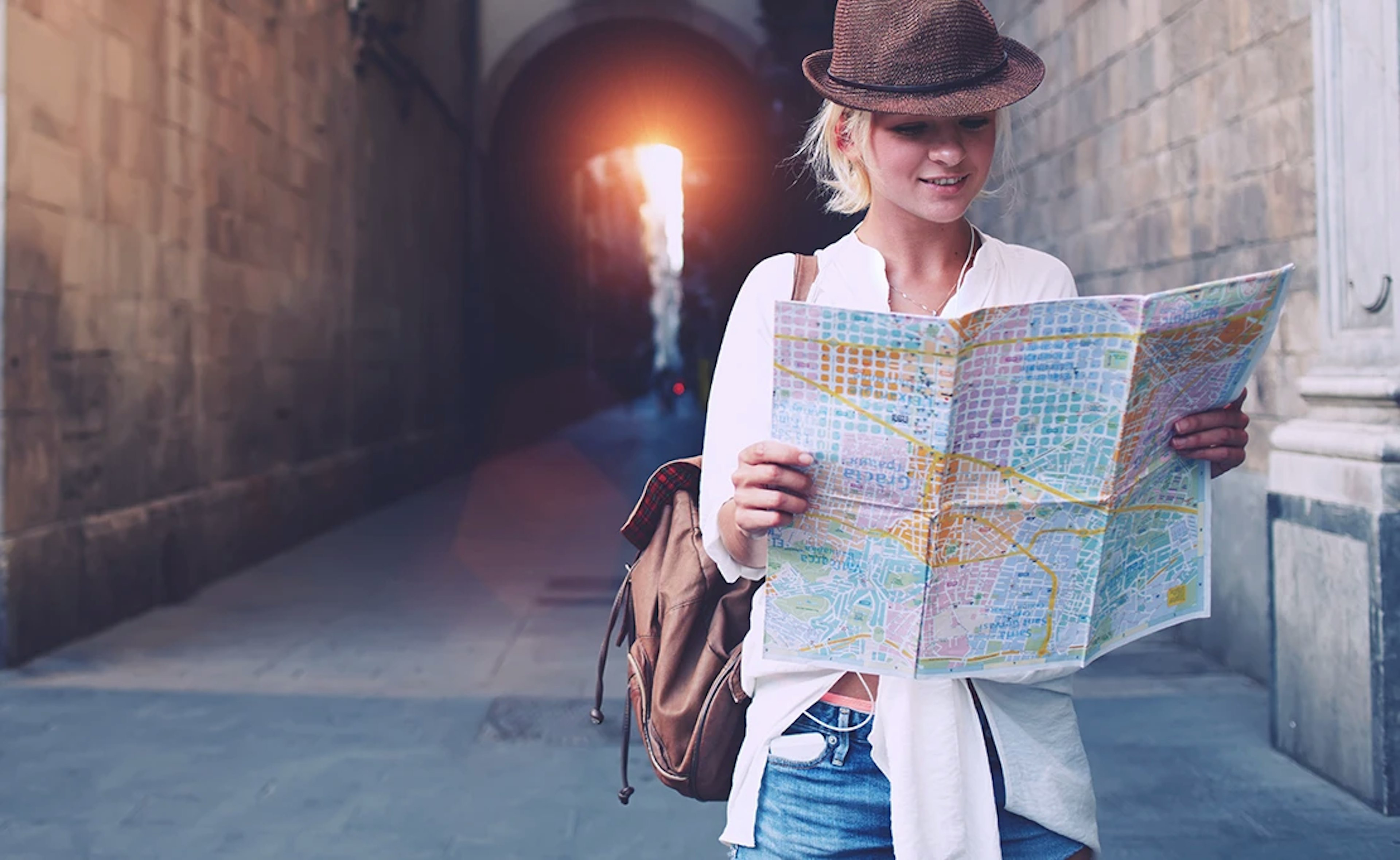 A woman holds a map in an unfamiliar town