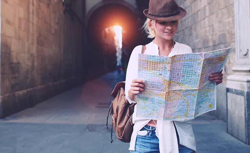 A woman holds a map in an unfamiliar town