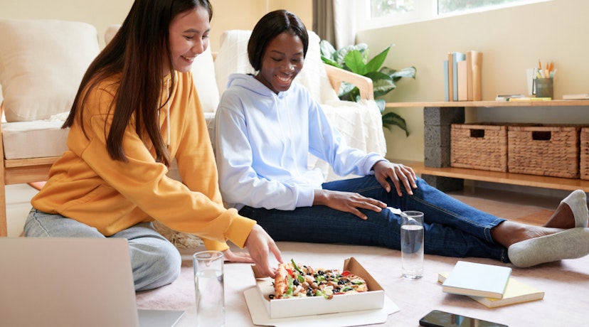 College students eating pizza and hanging out together after class.