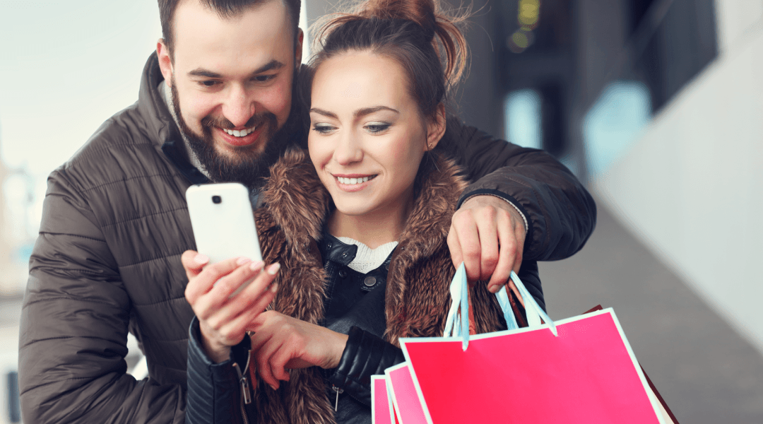 Couple shopping and looking at a phone
